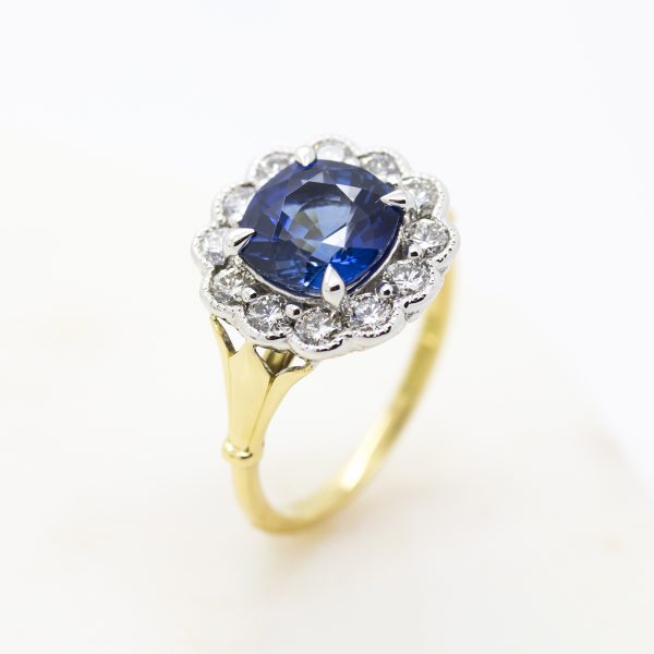 blue cushion cut ceylon sapphire with diamond halo in yellow gold and platinum