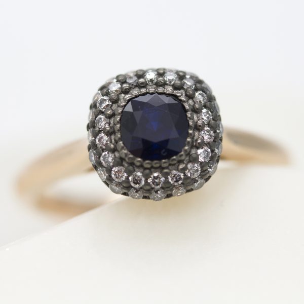 cushion cut blue sapphire with rhodium plated double diamond halo set in rose gold