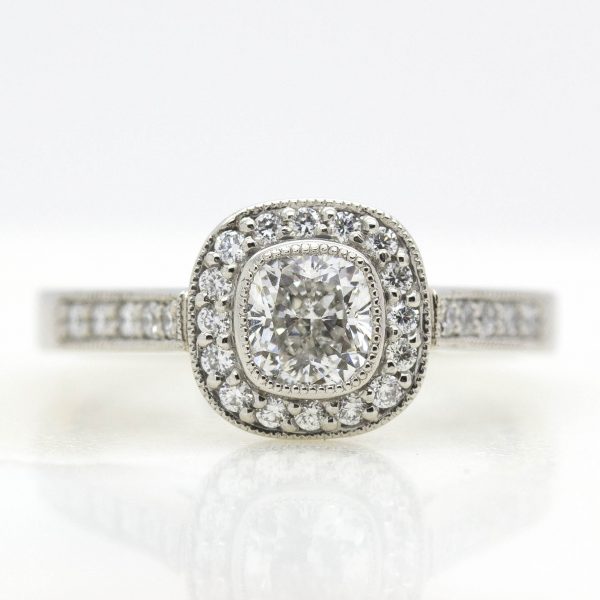 cushion cut diamond with diamond halo and milgrain engagement ring