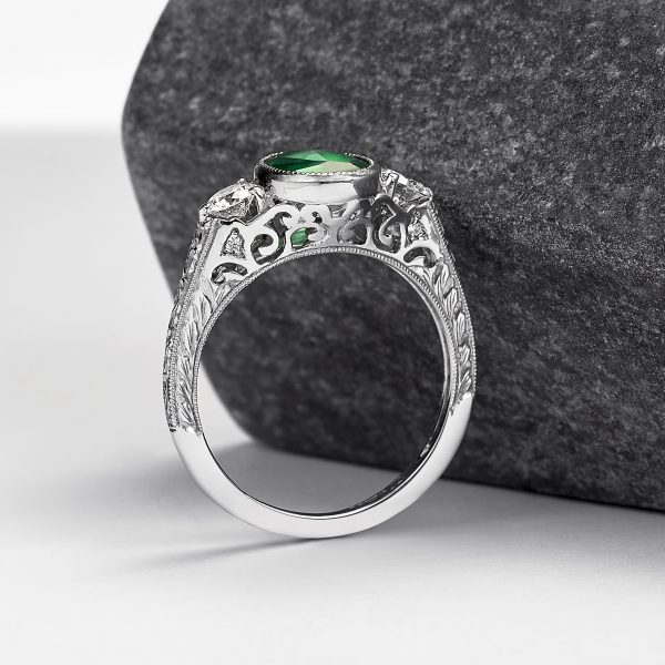 emerald engagement ring with filigree cut outs and hand engraved engagement ring