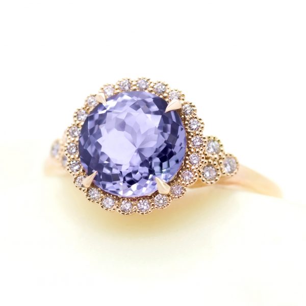 portuguese cut purple sapphire with diamond halo, accent stones and milgrain