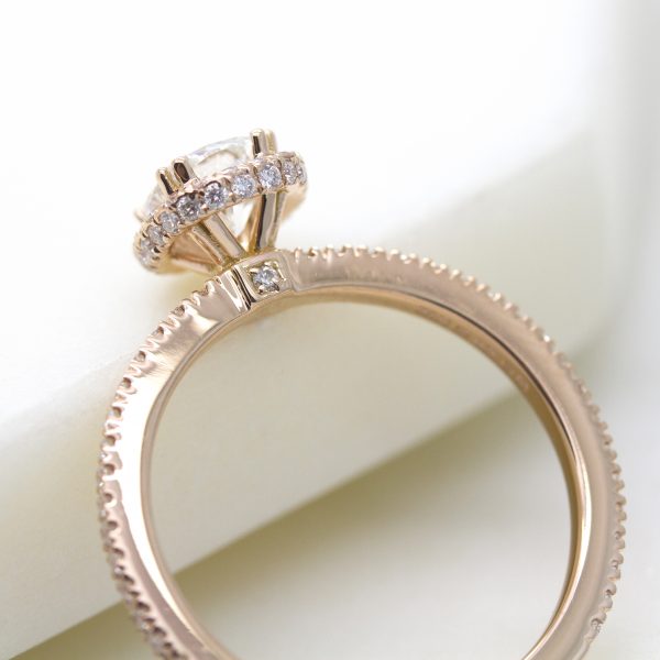 rose gold engagement ring with pave collet detail and pave set diamond on the bridge