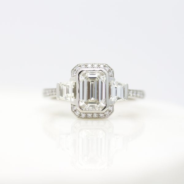 emerald cut diamond with north south halo and accent trapezoids