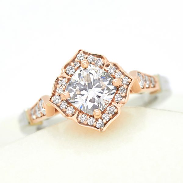 cushion cut diamond set on a bias with vintage inspired bead set halo in rose gold engagement ring