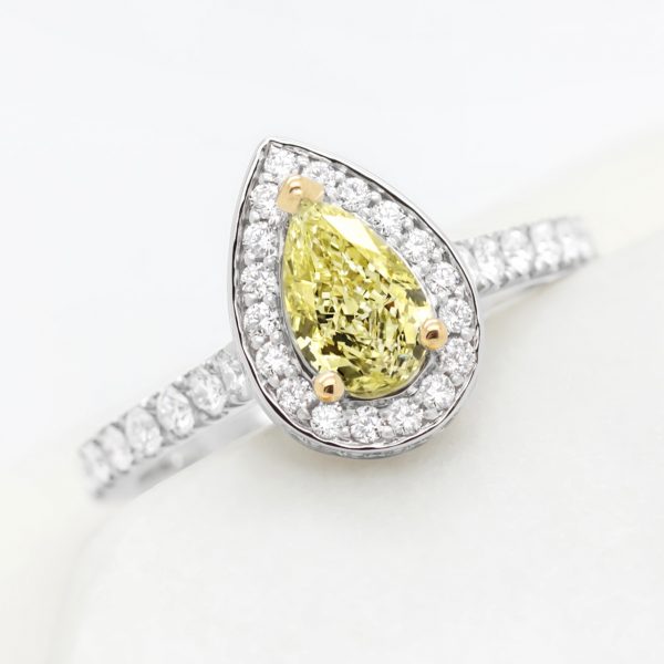 pear yellow diamond with yellow gold claws and platinum diamond halo engagement ring