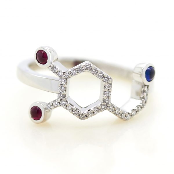 chemical science dopamine inspired engagement ring with blue sapphire and rubies