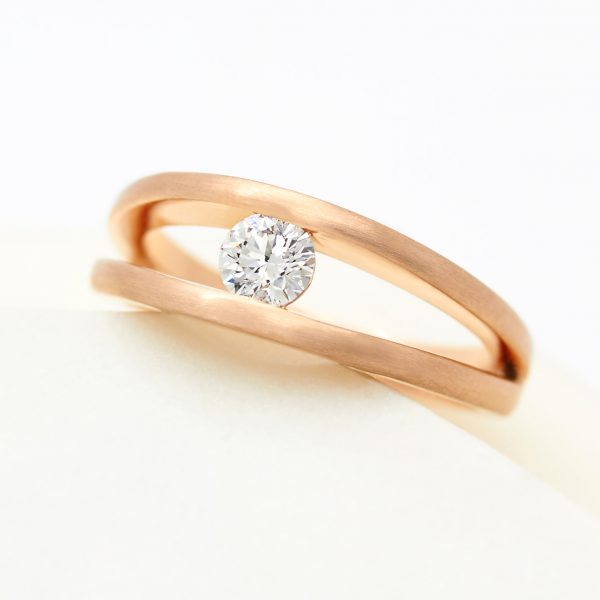 tension set split shank round diamond engagement ring in rose gold